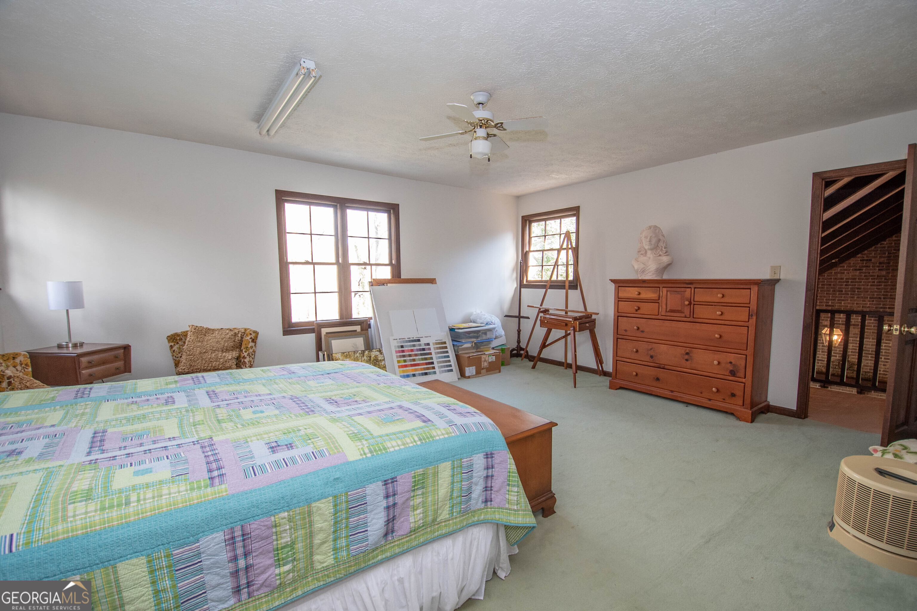 151 Evans Road Milner, GA 30257 - Photo 22 of 53 a bedroom with a bed and a dresser in it