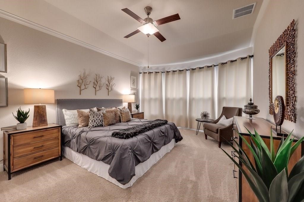 10825 Ballard Path Austin, TX 78717 - Photo 20 of 39 a spacious bedroom with a bed and a chandelier