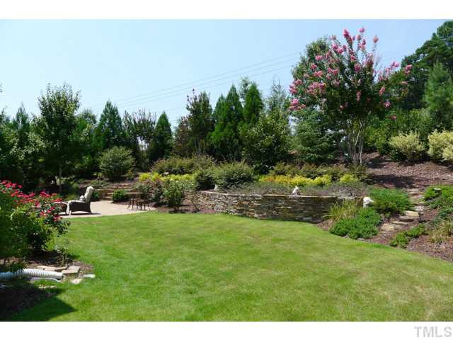 316 Powers Ferry Road Cary, NC 27519 - Photo 3 of 25 The backyard has a variety of trees and shrubs to include crepe myrtles, magnolias, hardwoods, pines, roses and more. There is also a natural stone retaining wall and pathway through the garden and a lush bed of Zoysia grass. Back Yard