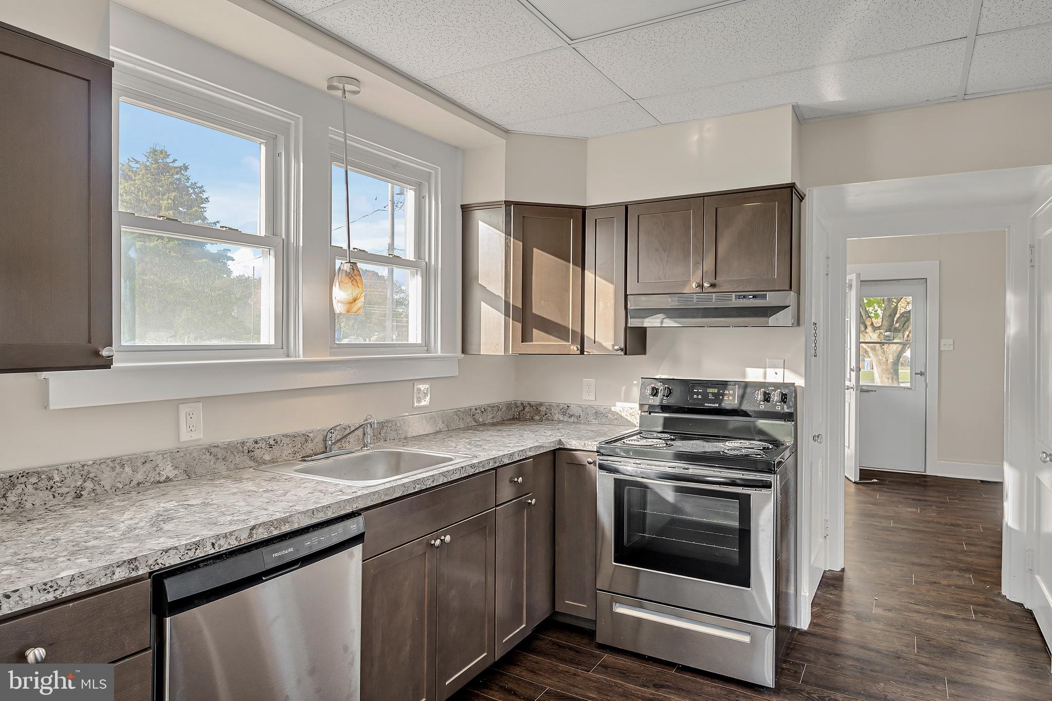 206 Hershey Road Hummelstown, PA 17036 - Photo 9 of 26 a kitchen with granite countertop a sink cabinets stainless steel appliances and a window