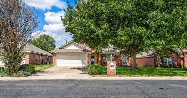 a front view of a house with a yard and a garage