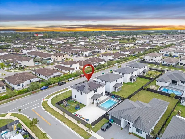 an aerial view of residential houses with outdoor space