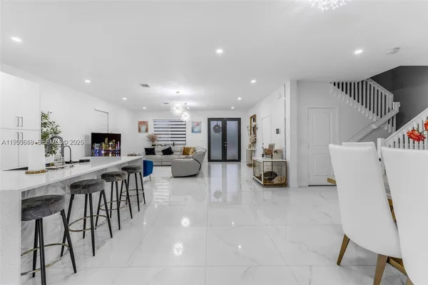 a living room with furniture a table and chairs
