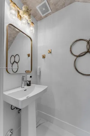 a bathroom with a sink vanity and mirror