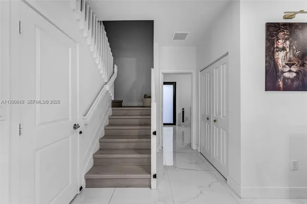 a view of a hallway with staircase