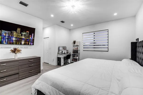 a bedroom with a bed and a book shelf