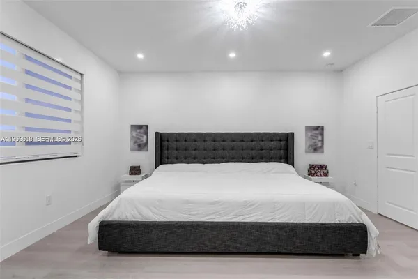 a bedroom with a bed and a night stand