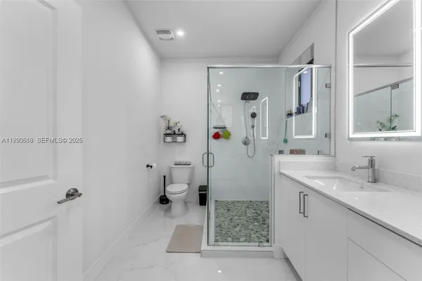 a bathroom with a sink toilet and shower
