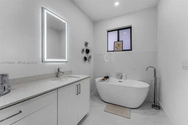 a spacious bathroom with a bathtub and mirror
