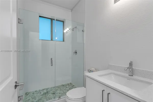 a bathroom with a sink toilet and vanity