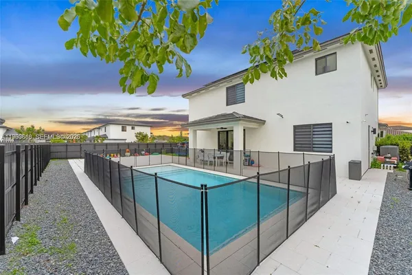 a view of a house with backyard and sitting area