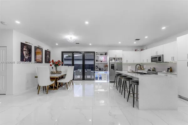 a living room with lots of furniture and kitchen view
