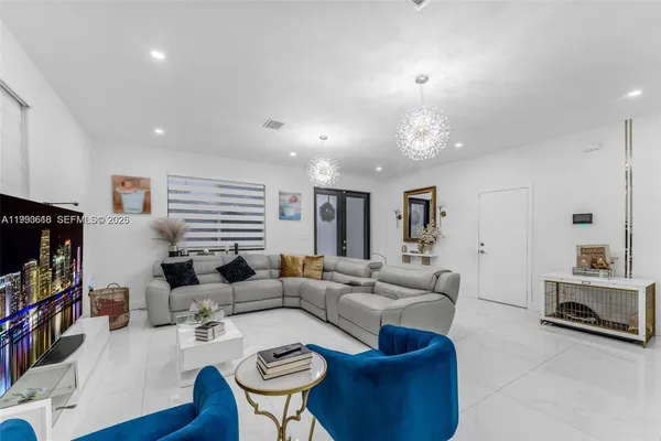 a living room with furniture a fireplace and a flat screen tv