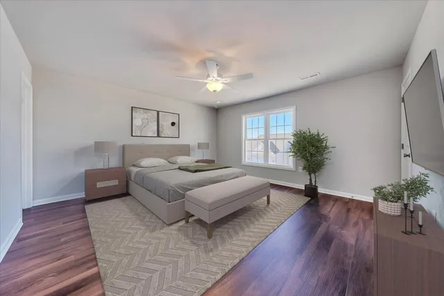 a spacious bedroom with a large bed and a chandelier