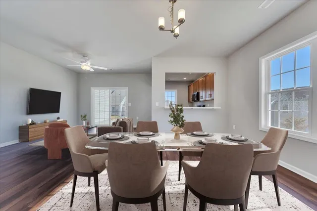 a dining room with furniture a window and wooden floor
