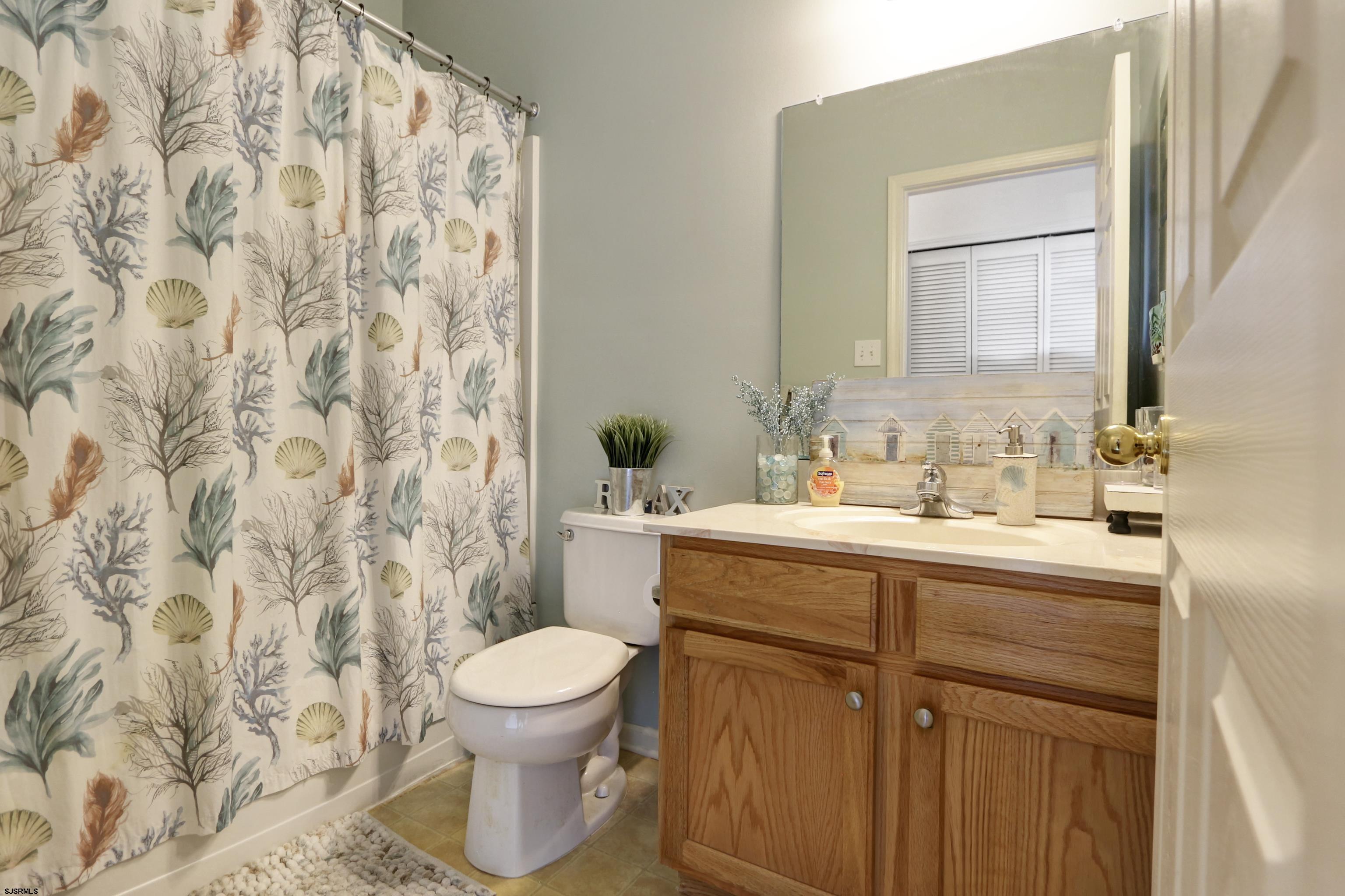 48 Gasko Road Mays Landing, NJ 08330 - Photo 22 of 30 a bathroom with a granite countertop sink a toilet and a mirror