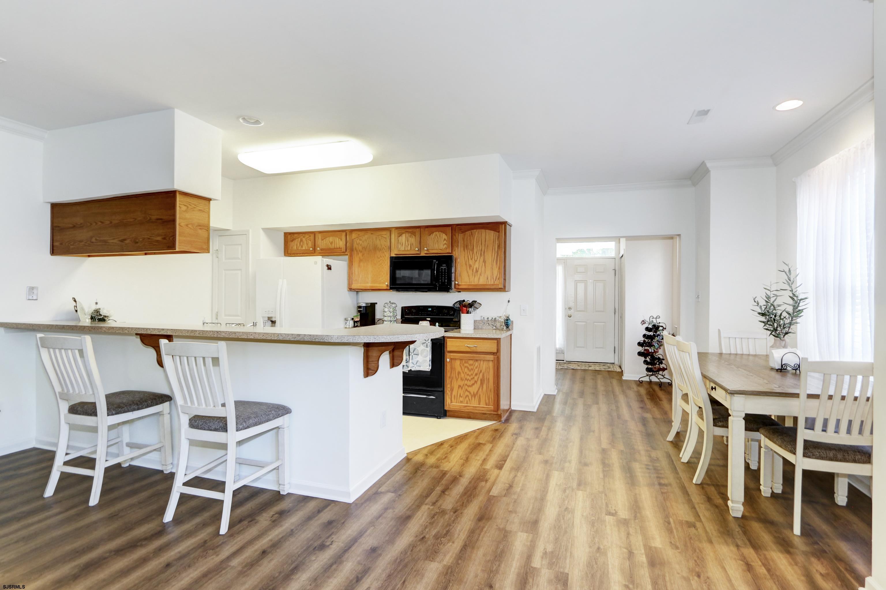48 Gasko Road Mays Landing, NJ 08330 - Photo 5 of 30 a open kitchen with stainless steel appliances granite countertop a stove top oven a sink a dining table and chairs with wooden floor