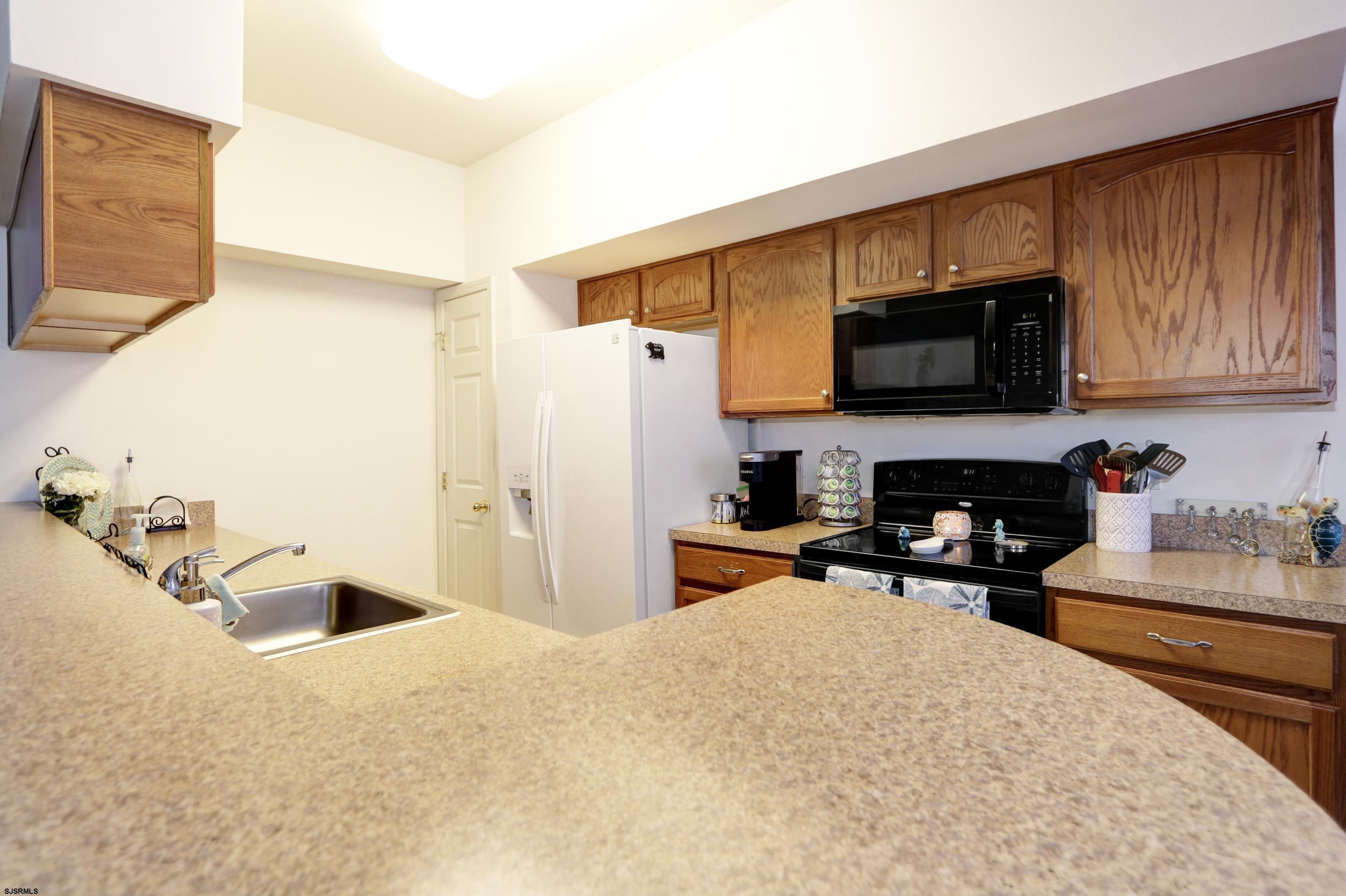 48 Gasko Road Mays Landing, NJ 08330 - Photo 9 of 30 a kitchen with a refrigerator a stove top oven a sink and cabinets