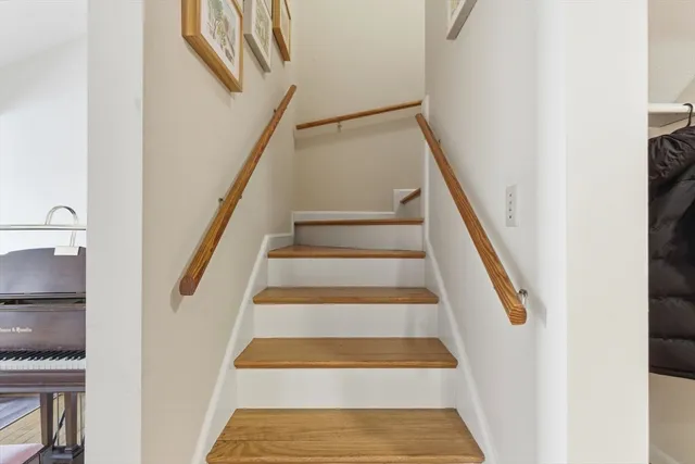 a view of staircase with white walls and a window