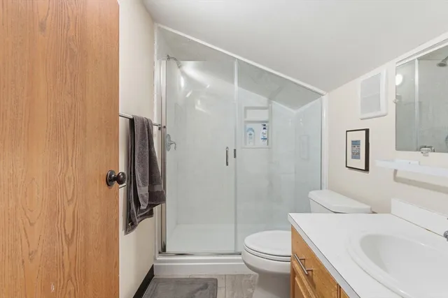 a bathroom with a sink toilet and shower
