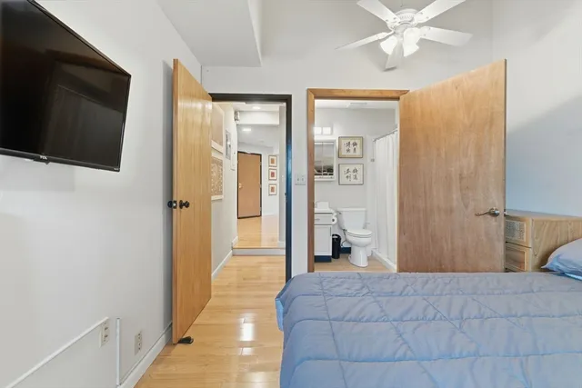 a bedroom with a bed and a flat screen tv