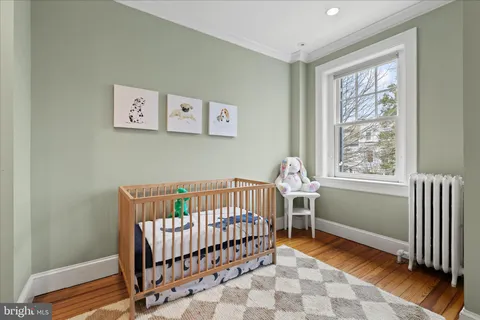 a living room with furniture a window and wooden floor