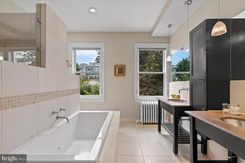 a kitchen with a sink a stove and cabinets