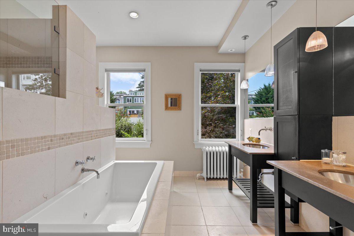 2816 27th Street Northwest Washington, DC 20008 - Photo 41 of 81 a bathroom with a bathtub sink and mirror
