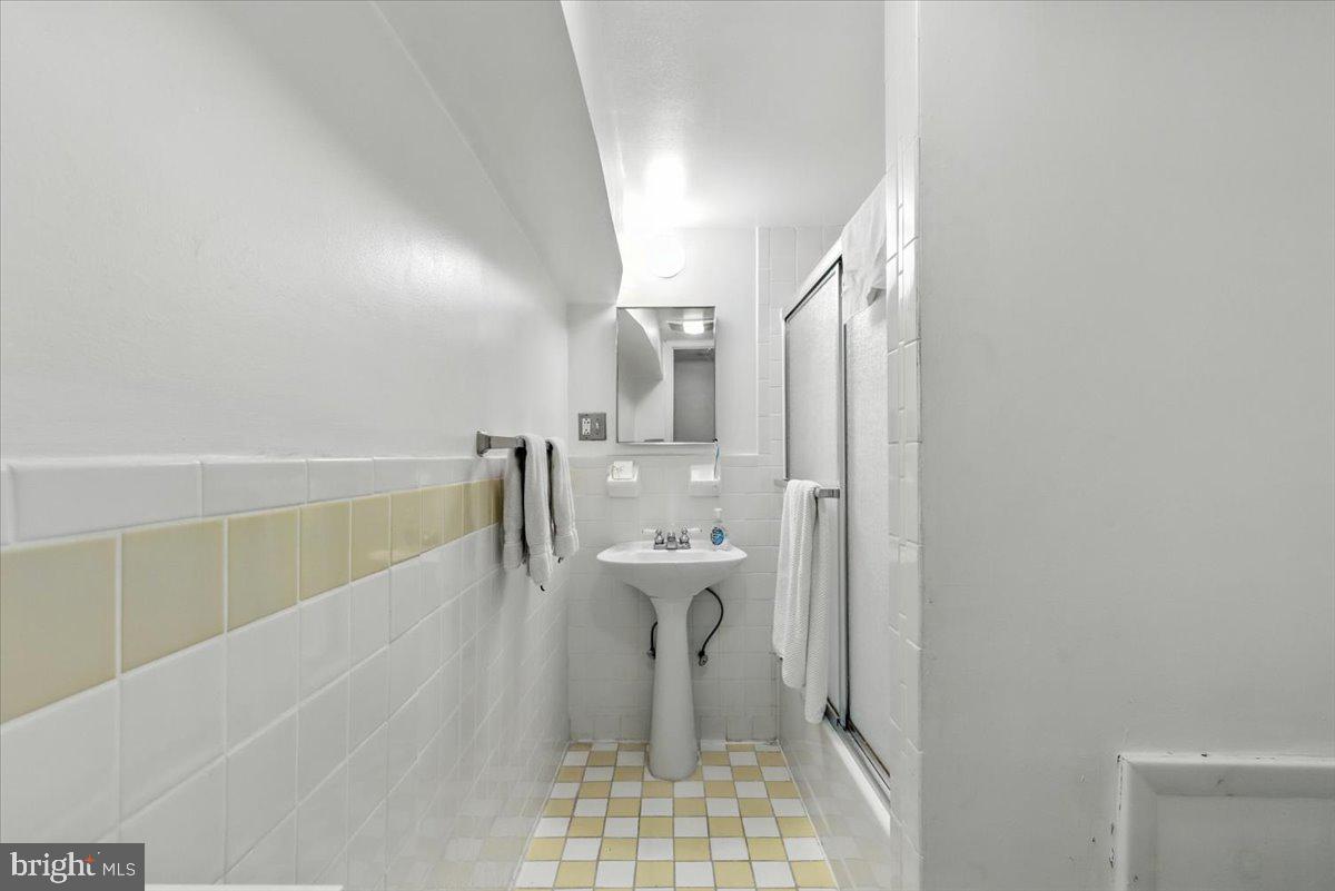 2816 27th Street Northwest Washington, DC 20008 - Photo 73 of 81 a bathroom with a sink a toilet and mirror