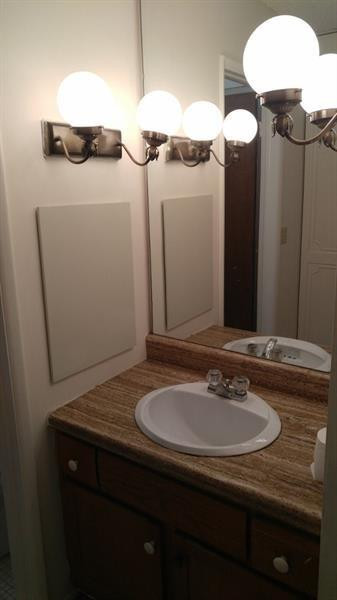 3750 Inverrary Drive, Unit Z2F Lauderhill, FL 33319 - Photo 11 of 12 a bathroom with a sink and mirror