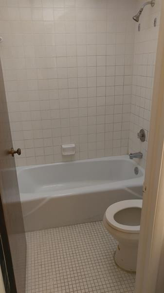 3750 Inverrary Drive, Unit Z2F Lauderhill, FL 33319 - Photo 12 of 12 a bathroom with a toilet and a bath tub