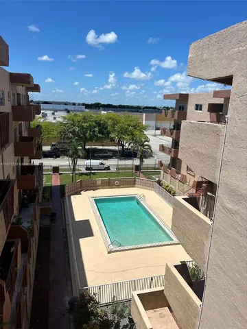 a kitchen with stainless steel appliances kitchen island granite countertop a sink counter space and a stove