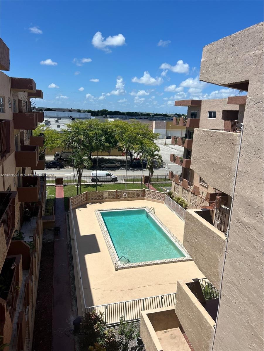 1630 West 46th Street, Unit 511C Hialeah, FL 33012 - Photo 2 of 12 a kitchen with stainless steel appliances kitchen island granite countertop a sink counter space and a stove