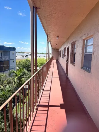 a view of balcony with wooden floor and fence
