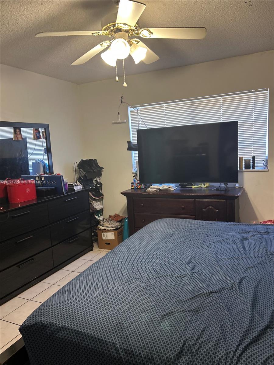 1630 West 46th Street, Unit 511C Hialeah, FL 33012 - Photo 10 of 12 a bedroom with a bed and a flat screen tv