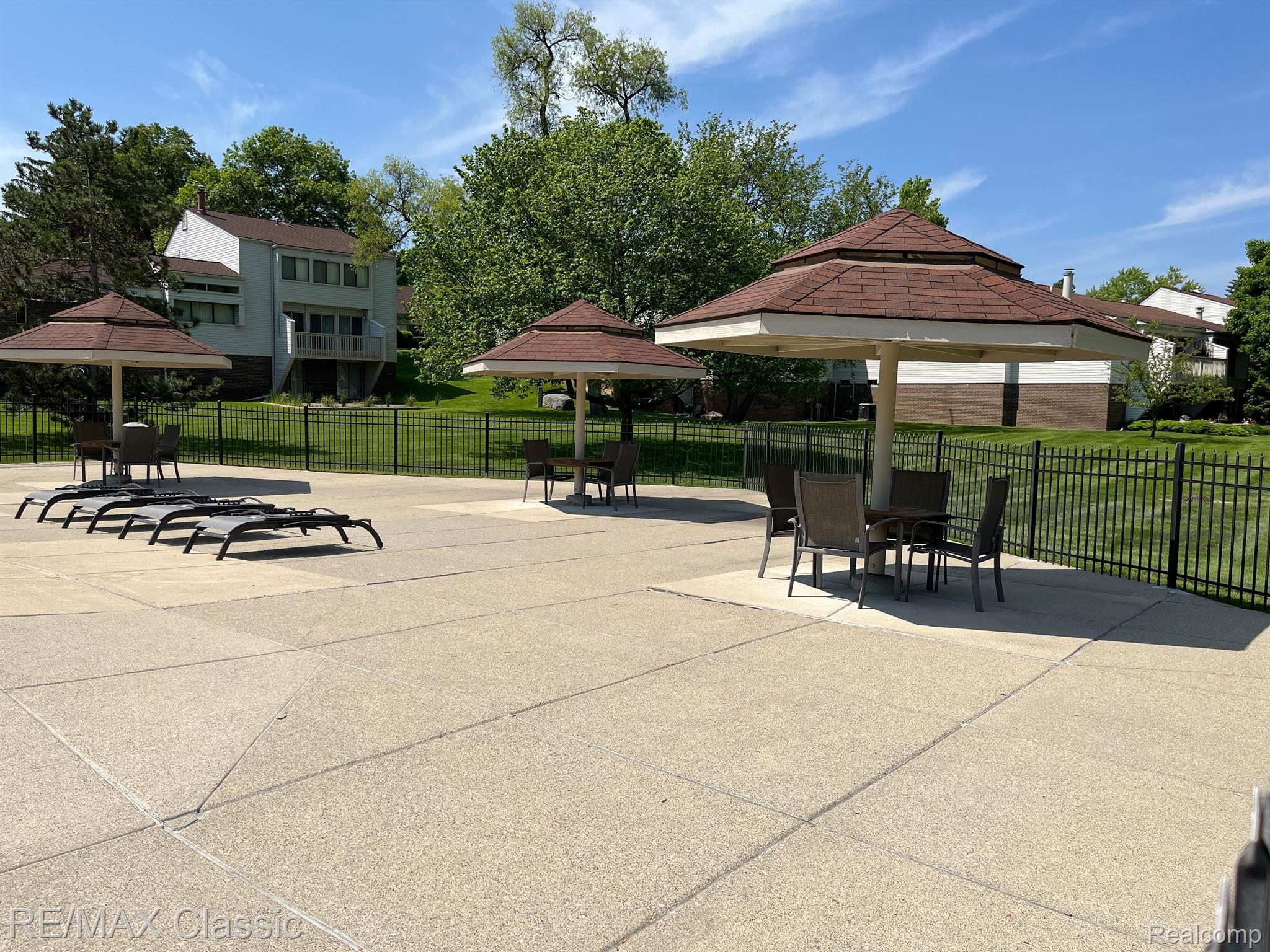 5249 Simpson Lake Road, Unit 70 West Bloomfield, MI 48323 - Photo 26 of 31 Pool area tables and chairs