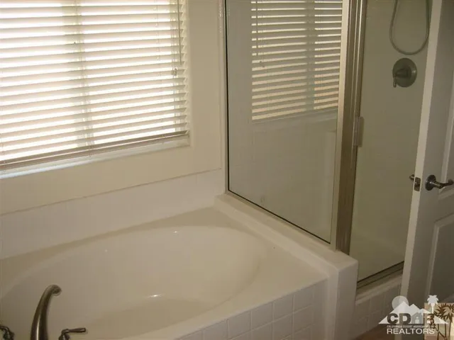 a bathroom with a bathtub and a shower