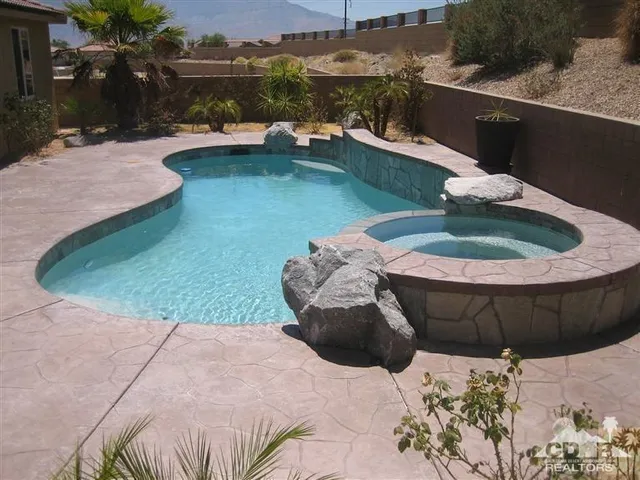 a view of a swimming pool with a yard