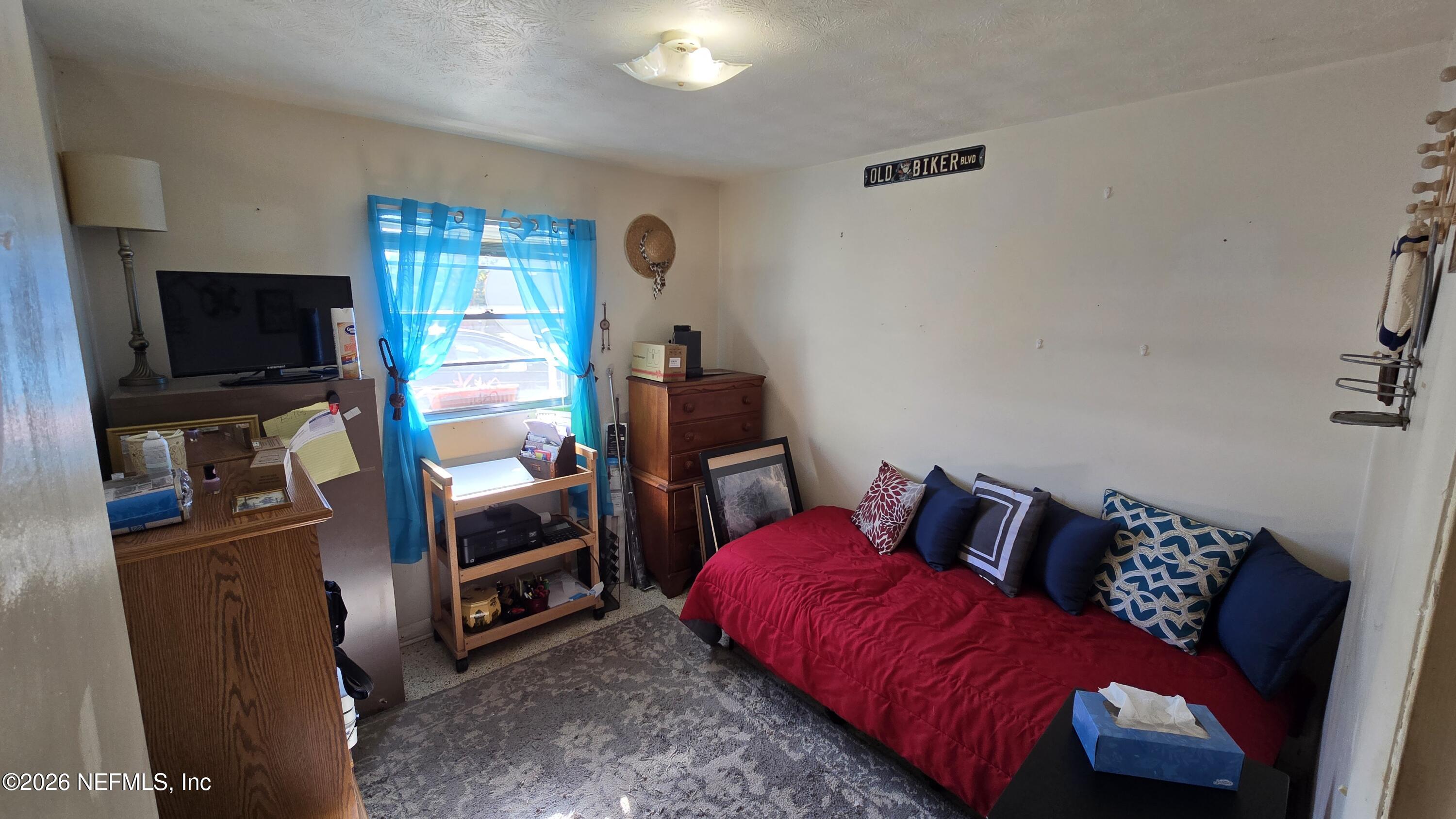 367 Southeast Tribble Street Lake City, FL 32025 - Photo 6 of 12 a bedroom with a bed and a television