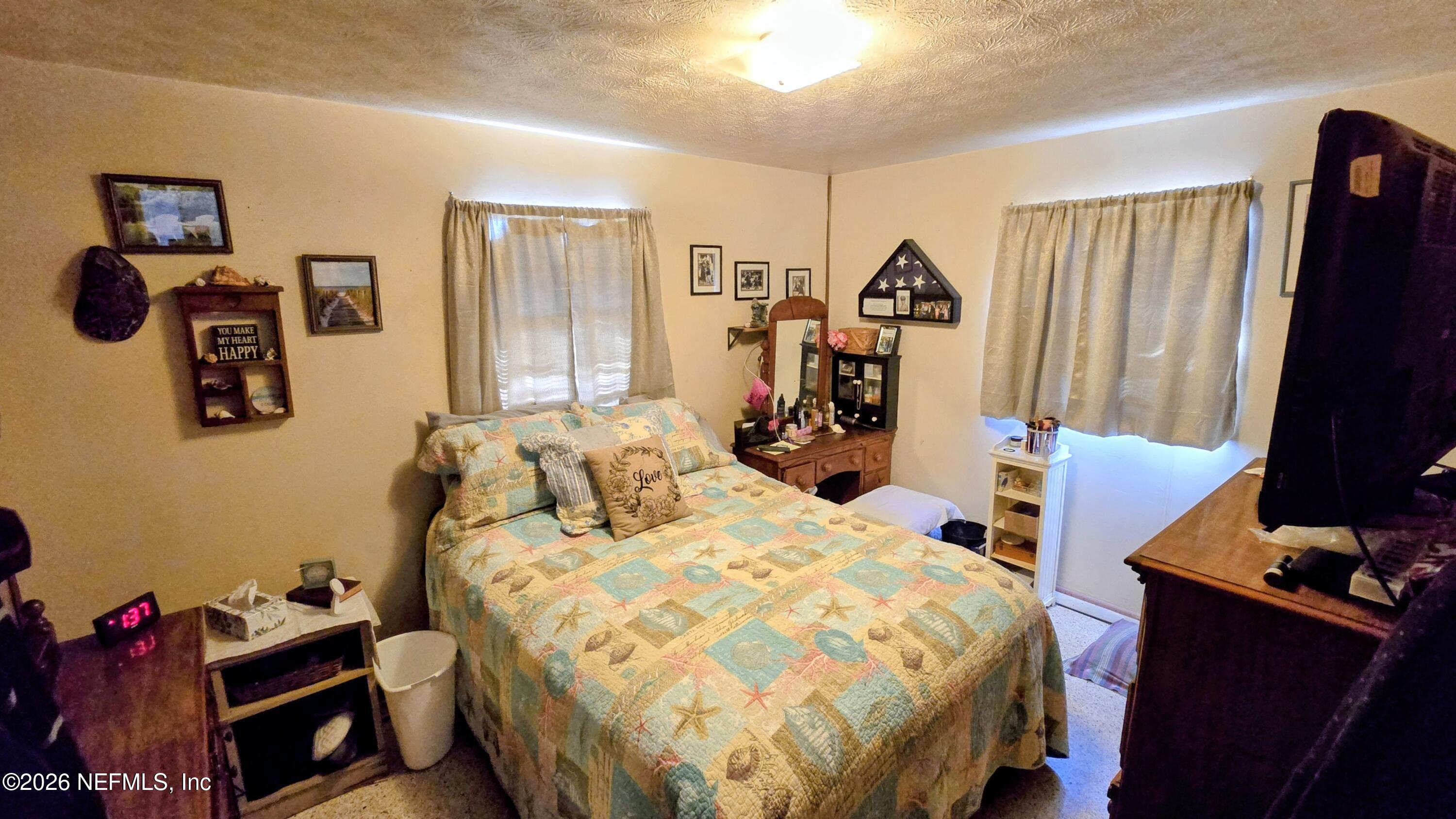 367 Southeast Tribble Street Lake City, FL 32025 - Photo 9 of 12 a bedroom with a bed and a flat screen tv