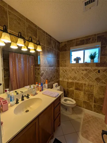 a bathroom with a sink mirror and toilet