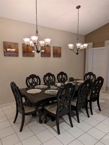 a view of a dining room with furniture and chandelier