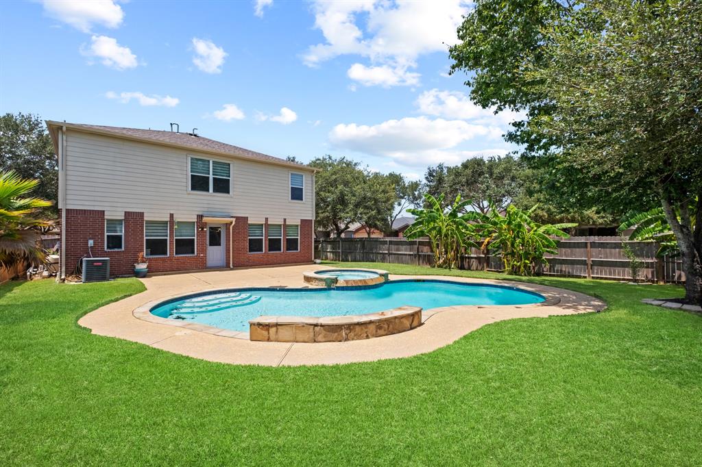 a view of a house with swimming pool and a yard