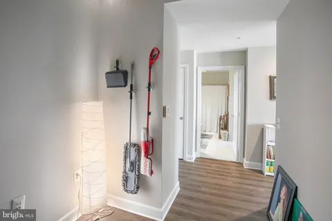 view of a hallway with wooden floor and closet