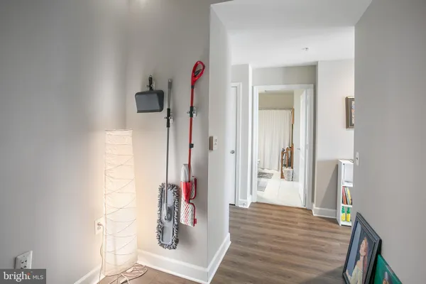 view of a hallway with wooden floor and closet