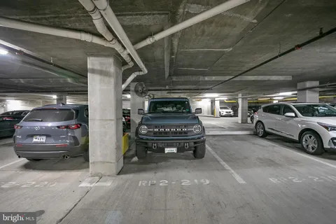 a view of parking garage with cars parked
