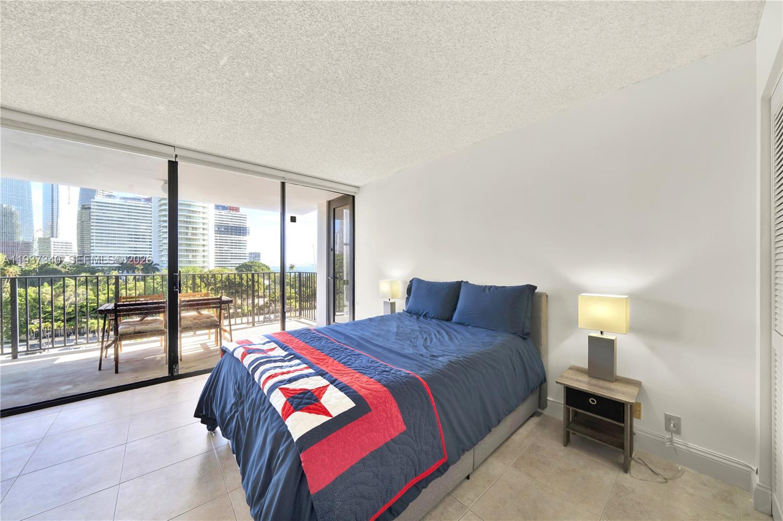 1901 Brickell Avenue, Unit B711 Miami, FL 33129 - Photo 14 of 41 a bedroom with a large bed and a large window