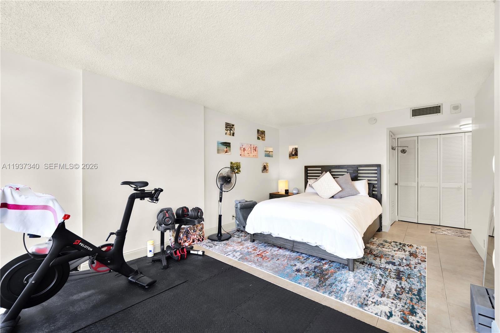 1901 Brickell Avenue, Unit B711 Miami, FL 33129 - Photo 18 of 41 a bedroom with a bed and gym equipment