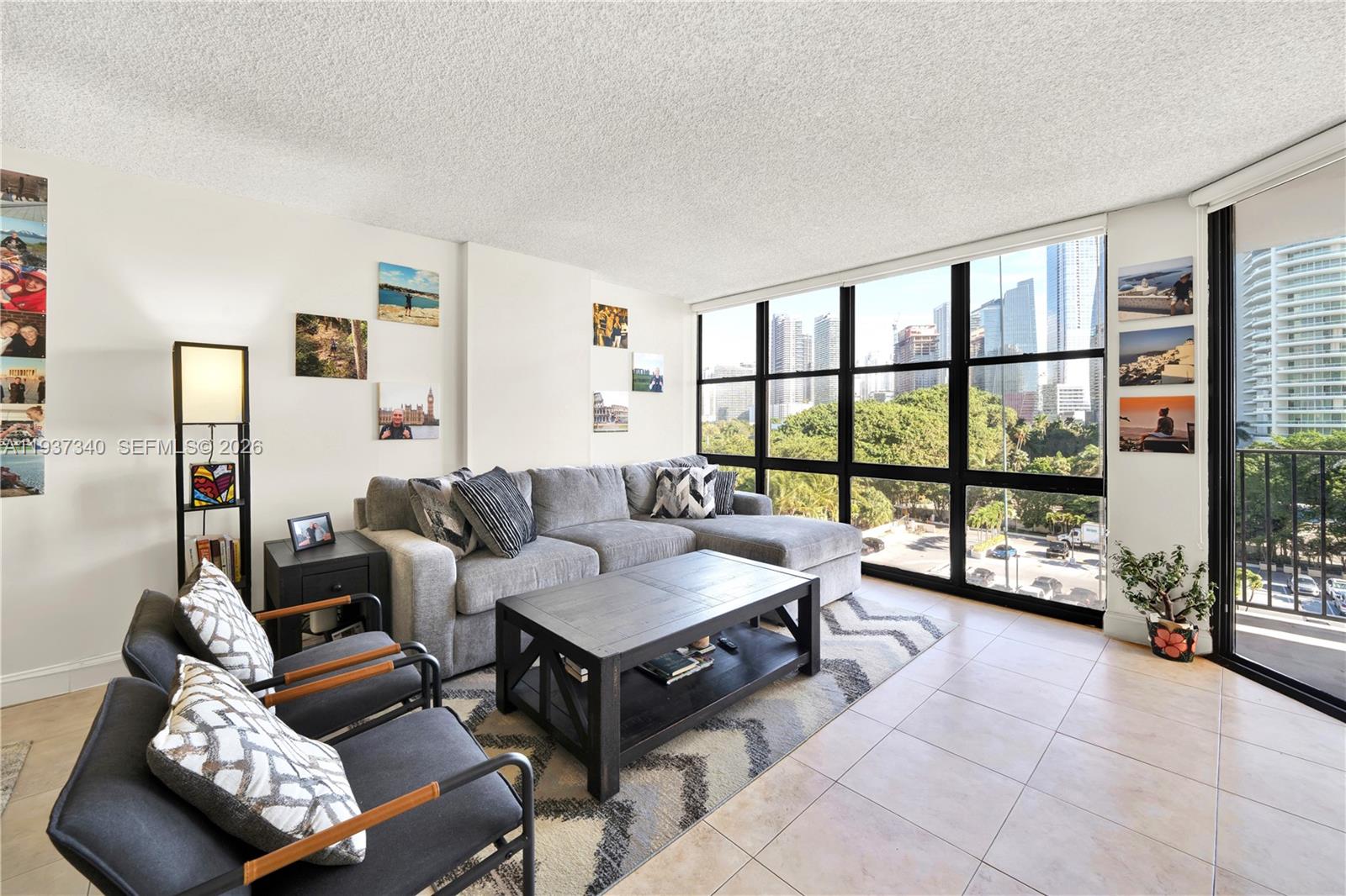 1901 Brickell Avenue, Unit B711 Miami, FL 33129 - Photo 3 of 41 a living room with furniture and a floor to ceiling window