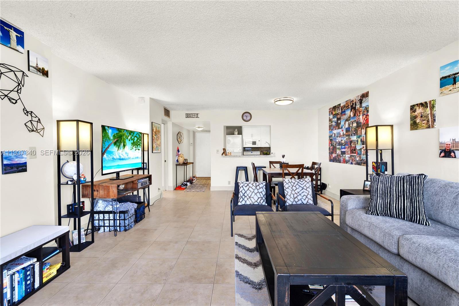 1901 Brickell Avenue, Unit B711 Miami, FL 33129 - Photo 5 of 41 a living room with furniture and a flat screen tv